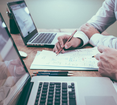 Laptops on Desk with Contracts